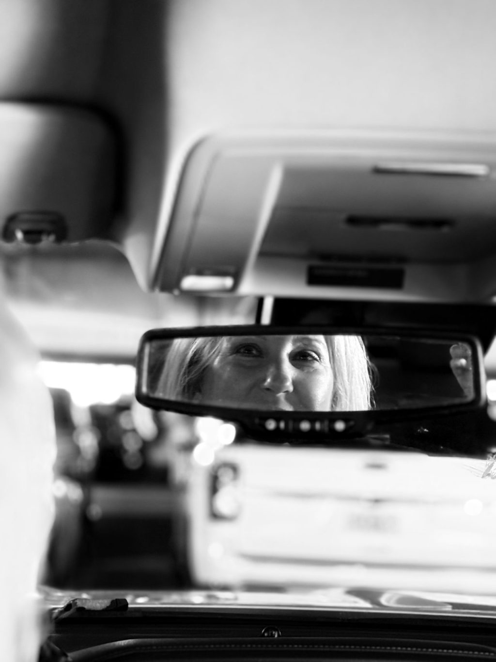 Picture of author looking in back from rearview mirror
