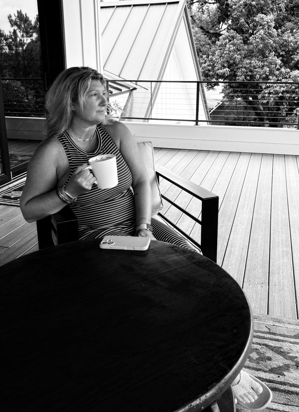 Picture of the author sitting with a cup of coffee and phone turned down. Thinking about her boundaries